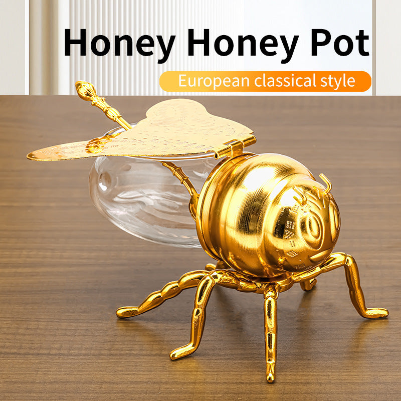 Tarro de miel con forma de abeja y cuchara, versátil y novedoso, ideal para condimentos, aceite, fiestas y utensilios de cocina.