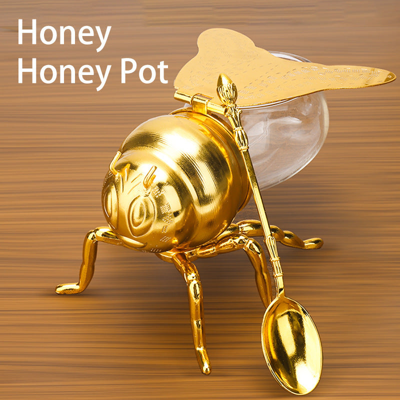 Tarro de miel con forma de abeja y cuchara, versátil y novedoso, ideal para condimentos, aceite, fiestas y utensilios de cocina.