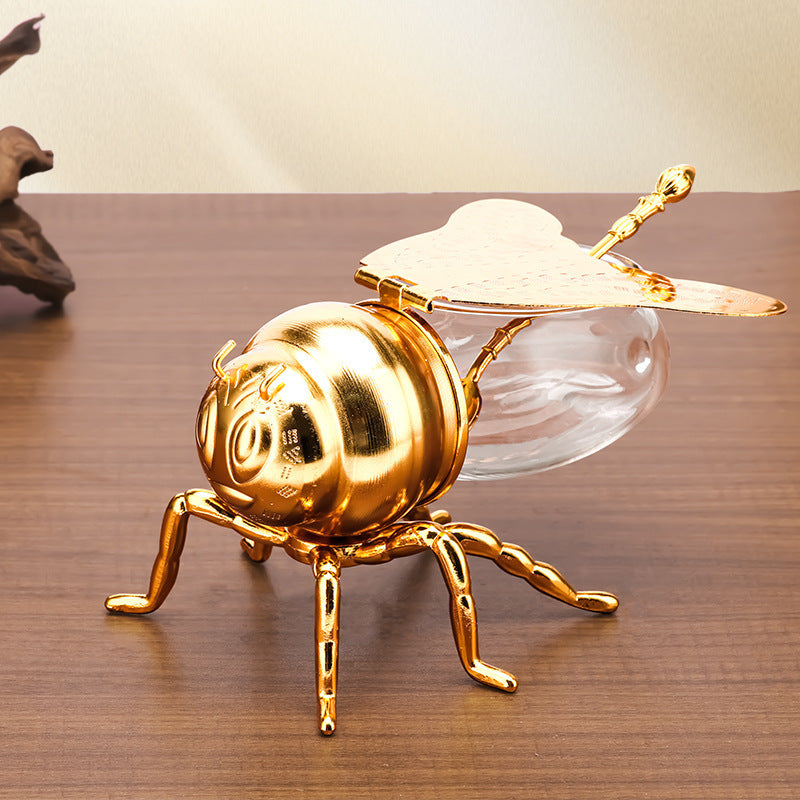 Tarro de miel con forma de abeja y cuchara, versátil y novedoso, ideal para condimentos, aceite, fiestas y utensilios de cocina.