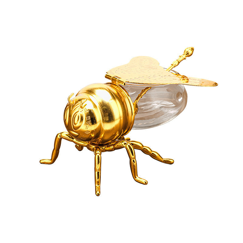 Tarro de miel con forma de abeja y cuchara, versátil y novedoso, ideal para condimentos, aceite, fiestas y utensilios de cocina.