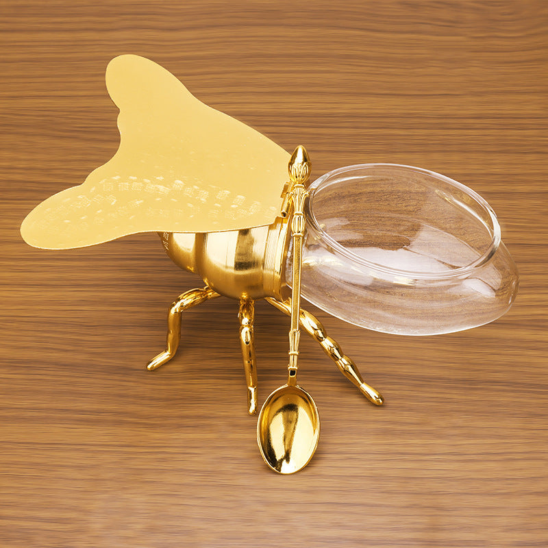 Tarro de miel con forma de abeja y cuchara, versátil y novedoso, ideal para condimentos, aceite, fiestas y utensilios de cocina.